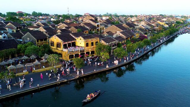 Aerial 4K drone footage of Hoi An city, Vietnam. Ancient town, UNESCO world heritage, at Quang Nam province. One of the most popular touristic destinations with many boats in river
