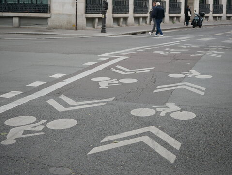 Numerous bicycle symbols on a street in Paris 