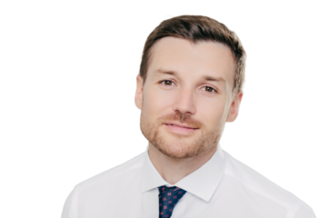 Close up portrait of self assured handsome businessman with stubble, being prosperous business owner, dressed elegantly, stands against white wall. Male boss poses indoor. People and success