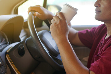 Closeup man drink coffee from paper cup in car. Concept, baverge for refreshing or helping to awake...