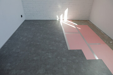 The process of installing quartz laminate. Repair and decoration of premises. Modern flooring. The texture of concrete.