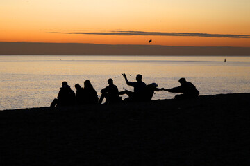 Fototapeta na wymiar Sunset at Brighton Beach with friends