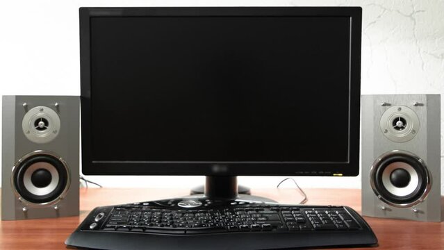 Work desk for digital job with computer, audio speakers and keyboard timelapse hyperlapse. Forward motion to the screen turning off and swithcing to black monitor