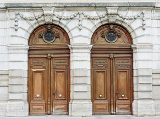 Monumental double wooden doors, with stone ornaments