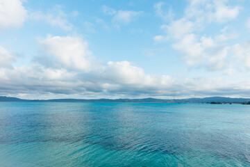 Beautiful cloudy sky and blue gradient seascape in Okinawa