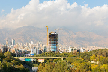 Fototapeta premium Skyline and cityscape of northern Tehran and Alborz mountain range viewed from the pedestrian Tabiat Bridge in Tehran, Iran.
