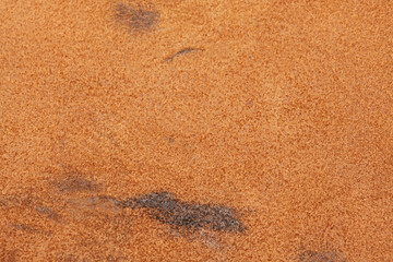 Light beige matte background of suede fabric, closeup.