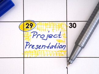 Reminder Project Presentation in the calendar with a blue pen.