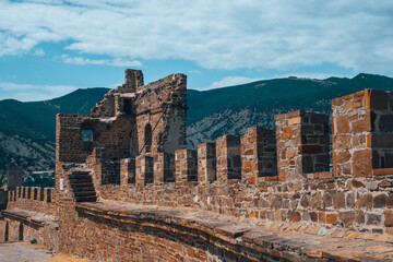 A fortress with towers on a rock.