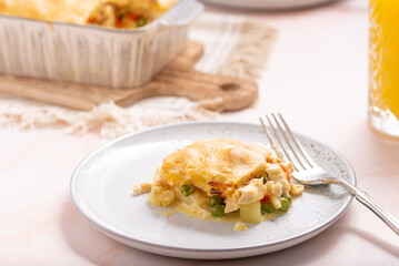 Pie on a Plate: Comforting Homestyle Chicken Pot Pie, A Classic Family Favorite with Flaky Golden Crust, Succulent Poultry, Vibrant Vegetables, and a Creamy Herb-infused Filling, Baked dish