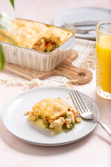 Pie on a Plate: Comforting Homestyle Chicken Pot Pie, A Classic Family Favorite with Flaky Golden Crust, Succulent Poultry, Vibrant Vegetables, and a Creamy Herb-infused Filling, Baked dish