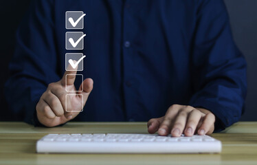 Businessman checks a check mark on the checklist with a check mark	