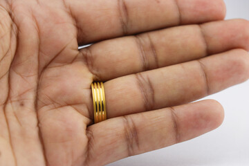 Gold ring worn on the finger. Gold wedding ring worn on the ring finger