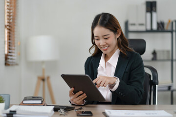 Happy Confident young asian businesswoman working with tablet Start up small business owner. business successful technology concept.