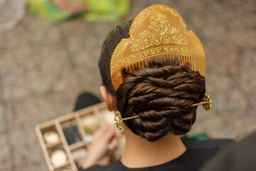 Close-up of a traditional Fallera woman's hairstyle in Spain, featuring a golden comb as a striking accessory.