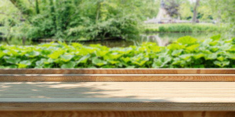 Empty wooden table outdoors, green park nature background, product display template