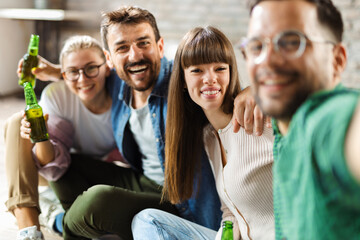 Happy friends taking a selfie with smart phone at home