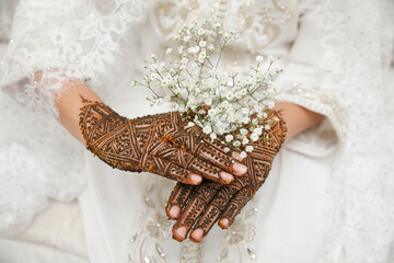 Picture of human hand being decorated with henna Tattoo. mehendi hand.