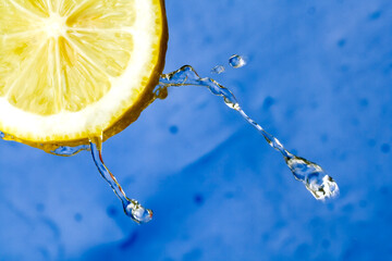Yellow refreshing lemon against the blue background