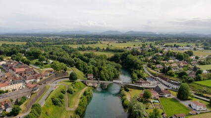 Beautiful panorama of the stream of the gave of Oloron with a bridge giving visibility on a little of the city of Navarrenx and a lot of Pyrenean countryside surrounding the area naturally