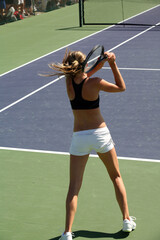 Fototapeta na wymiar Woman playing tennis at the professional tournament