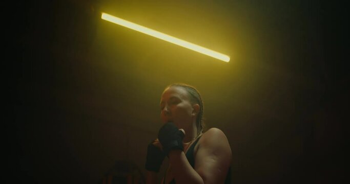 sportswoman training in gym, practicing punches for defending and attacking, portrait, 4K, Prores