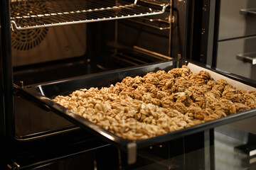 Roasted baked walnuts close up on a baking sheet