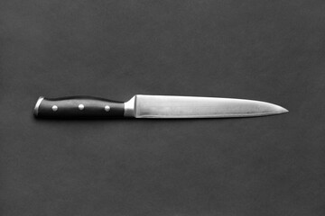 Large kitchen knife on a black background, copy space.