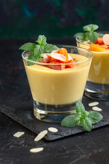 Creamy peach dessert with peach pieces and mint.