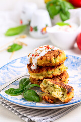 Zucchini ftitteres with spicy sauce.