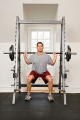 Fototapeta na wymiar Man lifting weights in gym.