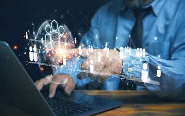 Businessman use computer to touch virtual human icons with networks online for customer...
