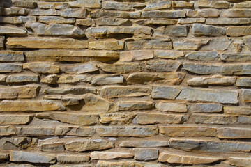 The stone wall texture background natural color.