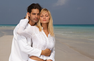 Romantic young couple spending time at the beach