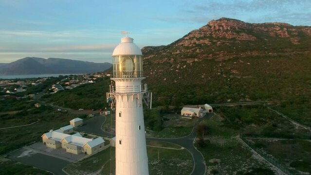 Sunset, drone and ocean with landscape of lighthouse nature, travel beacon and coastal landmark. Adventure, peace and seascape with sunrise and coastal light beam tower for safety and destination