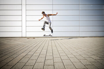 skater making a flip with his skateboard