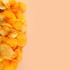 Border of potato chips isolated on creamy colored background. Irresistibly crunchy snack with a hint of sweetness