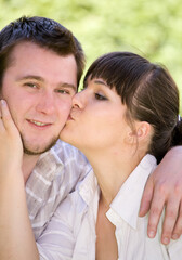 Fototapeta premium happy couple together sitting on grass