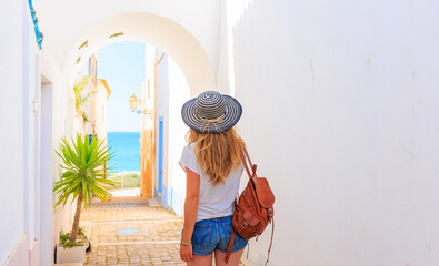 Woman tourist walking in the street in Portugal- Tourism in Algarve