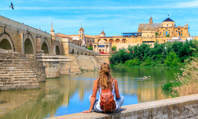 Woman tourist enjoying beautiful view of Cordoba city and bridge- Spain - obrazy, fototapety, plakaty