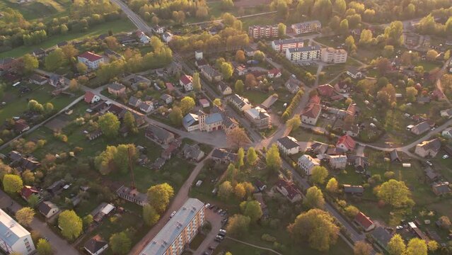 A small border town in Latvia. Valka city at sunset. Drone flight over the city
