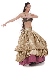 Beautiful belly dancer in rich costume over white background