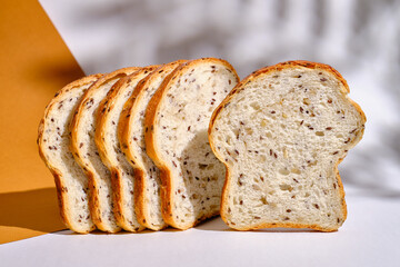 Fresh sliced bread on toast on plates on a light background. Sweet pastries. Food and nutrition concept
