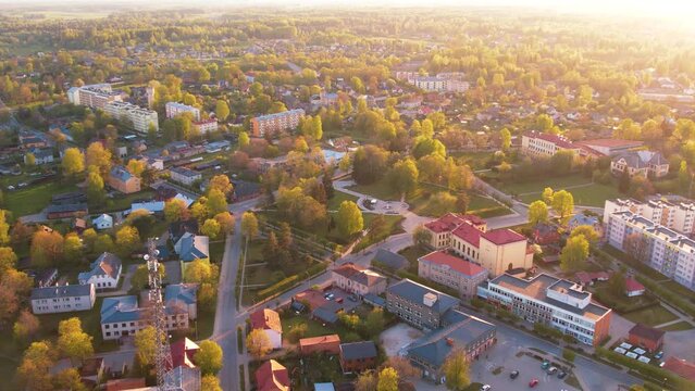 A small border town in Latvia. Valka city at sunset. Drone flight over the city