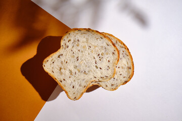 Fresh sliced bread on toast on plates on a light background. Sweet pastries. Food and nutrition concept