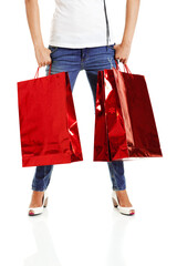 Beautiful young woman with red shopping bags. Consumerism Concept