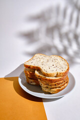 Fresh sliced bread on toast on plates on a light background. Sweet pastries. Food and nutrition concept
