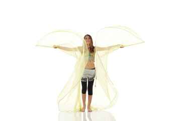 Young Caucasian belly dancing girl in beautiful decorated clothes on white background and reflective floor. Not isolated
