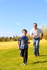 Portrait of father and son playing outdoors