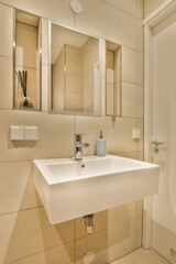 a bathroom with a white sink and mirror above the sink is an image of a toilet in front of it